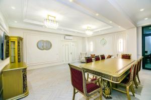 a dining room with a table and a couch at Deluxe Apartment 15/1 in Baku