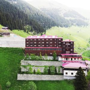 a building with a pink roof on a hill at Lahza Hills Resort in Çaykara
