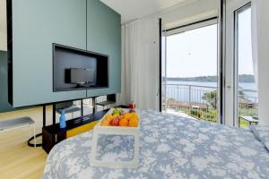a bedroom with a bed with a tray of fruit on it at Blue Breeze Apartment in Salò