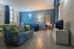 a living room with a couch and a tv at Housing Giulia in Turin