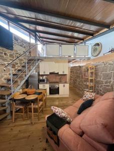 a living room with a couch and a table at O Capricho in Requeixo +15 photos