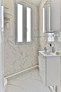 ein weißes Bad mit einem Waschbecken und einem WC in der Unterkunft Magnifique 2 pieces aux portes de Paris in Gagny