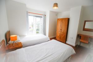 a bedroom with two beds and a window at Seacliff HH No 4 in Dunmore East