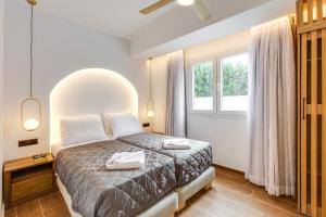 a bedroom with a bed and a window at Villa Envy by Villa Plus in Malia +12 photos