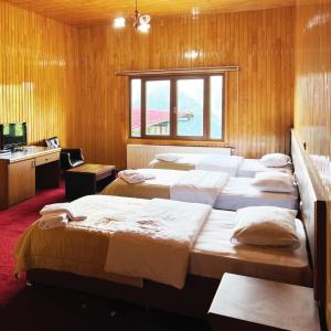 a row of beds in a room with a window at Lahza Hills Resort in Çaykara +116 photos