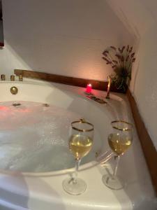 zwei Gläser Wein in einer Badewanne mit Kerzen in der Unterkunft Your luxury room Civitella in Civitella dʼAgliano