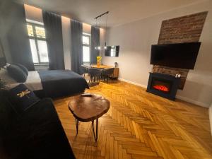 a living room with a bed and a fireplace at Więzienna Old Town in Wrocław +10 photos