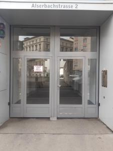 an entrance to a building with two glass doors at Apartment Dahlia Vienna in Vienna