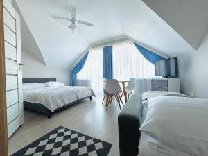 a bedroom with two beds and a window at Willa Przystań in Jastarnia