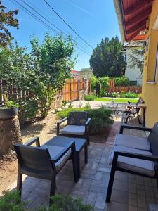 a group of benches sitting on a patio at Lena apartment - Lena two bedroom apartment in Vecsés
