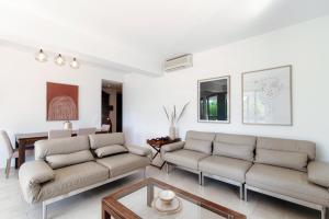 a living room with two couches and a table at The Central Home by Quokka 360 - Next to Lido di Lugano in Lugano