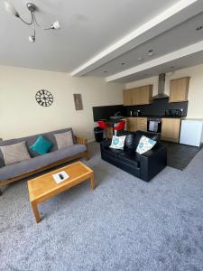 a living room with a couch and a coffee table at 2 large bedroom apartment- WIFI & Parking in Fleetwood