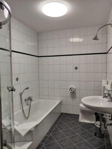 a bathroom with a tub and a toilet and a sink at Neuhof in Neuhofen an der Ybbs