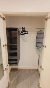 シェフィールドにあるCompact Studio Serviced Apartment Sheffield City Centre - Netflix, WiFi, Digital TVの棚付きのクローゼットと鏡が備わる客室です。