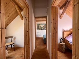 um corredor que leva a um quarto com vigas de madeira em Gästewohnung auf dem Heilandhof 