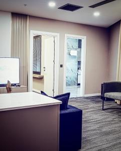 an office with a white counter and chairs and a screen at ONKA OTELCİLİK TURİZM TİCARET LİMİTED ŞİRKETi in Istanbul