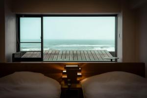 Ένα ή περισσότερα κρεβάτια σε δωμάτιο στο Kameya Hotel