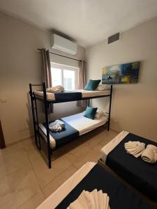 a room with three bunk beds and a window at Belle Apartments in St Julian's