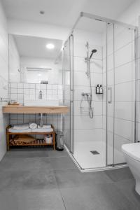 a bathroom with a shower and a sink at HOTEL CAMINO do EUME in Puentedeume