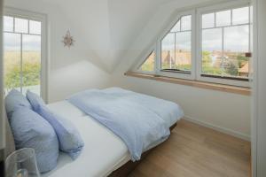 Ένα ή περισσότερα κρεβάτια σε δωμάτιο στο Haus Dünenkate Sandbank12