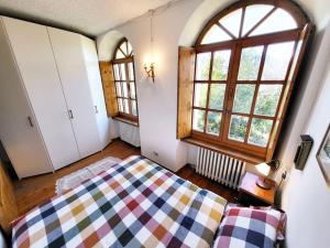 a bedroom with a bed and a large window at Cretallaz - Rustic chic with castle view, free parking and WiFi in Saint-Pierre