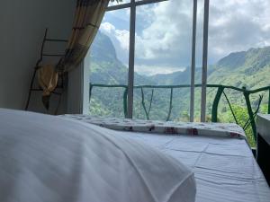 a bed in a room with a view of a mountain at Naked privacy & Paradise view in Ella +36 photos