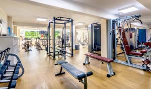 a gym with a lot of treadmills and machines at VIVA Blue & Spa in Playa de Muro