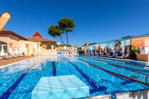 a swimming pool with a chaise lounge in a hotel at VIVA Blue & Spa in Playa de Muro