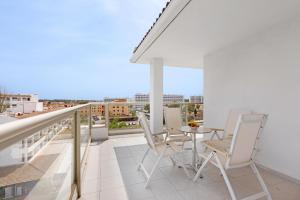 a balcony with chairs and a table on a roof at VIVA Sunrise in Port d'Alcudia