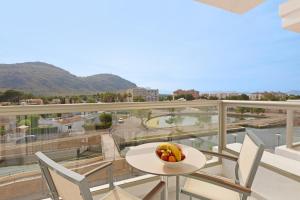 a bowl of fruit on a table on a balcony at VIVA Sunrise in Port d'Alcudia
