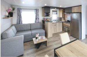 a living room with a couch and a kitchen at Mobilhomme camping in Fréjus