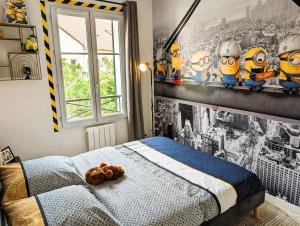 a bedroom with a bed with a teddy bear on it at Le Repaire - 10min Disney - Familial - Centre Ville in Bailly-Romainvilliers +41 photos