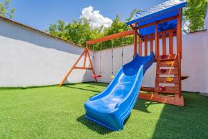 a playground with a blue slide and a ladder at Villa Green in Mostar