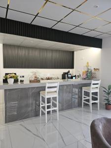 a kitchen with a counter and two stools at Polyxeni Hotel Apartments in Limassol