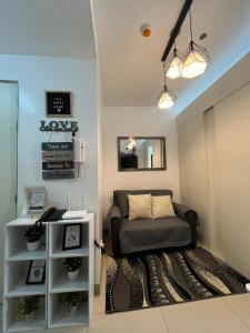 a living room with a couch and a table at The Happy Home at Smdc Cool Suites Wind Residences in Tagaytay +44 photos