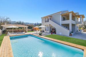 a villa with a swimming pool and a house at Villa Alegria a Casa II by Villa Plus in Sfakerá
