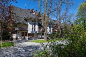 a large house with a black roof at Rent like home - Sienkiewicza in Zakopane