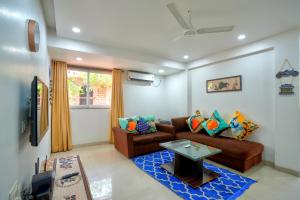a living room with a couch and a table at Luxurious Nirvana Apartments at Vagator in Vagator