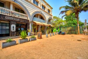 a street in front of a building with potted plants at Luxurious Nirvana Apartment 2BHK in Vagator