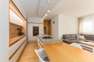 a kitchen and living room with a couch and a table at Stadtdomizil Schladming by Schladming-Appartements in Schladming