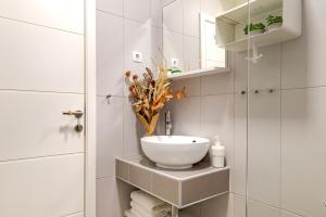 a bathroom with a white bowl sink on a counter at Charming renovated apartment next to the sea in Šibenik +21 photos