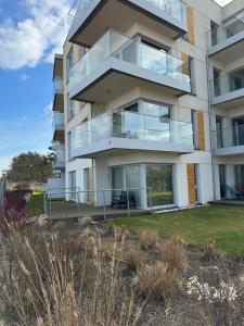 an apartment building with balconies on the side of it at Apartament przy plaży 9 in Mielno