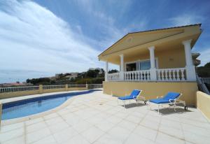Villa mit einem Pool und 2 Stühlen in der Unterkunft Villa Belgica Premium Vista Panoramica in Peñíscola