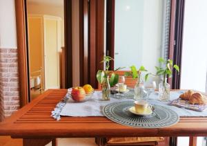 a wooden table with a plate of food on it at HoliHome_Parri in Tortoreto Lido