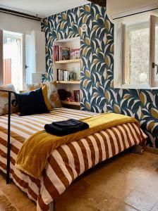 a bedroom with a bed with a blue and white wallpaper at Triplex de Saint-Paul Free public parking in Saint-Paul-de-Vence