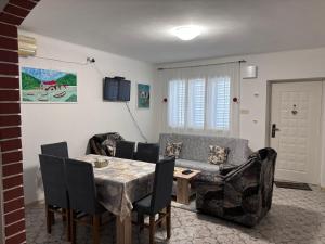 a living room with a table and a couch at Apartments Matija in Sutomore