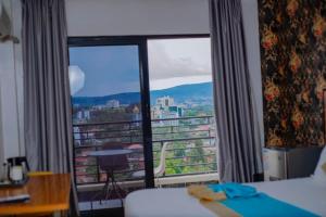 a hotel room with a large window with a view at Centric Hotel in Kigali
