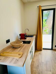 a kitchen with a wooden counter top with a sink at Zina in Cassis +6 photos