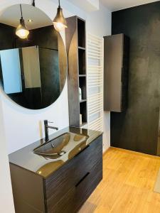 a bathroom with a sink and a mirror at Zina in Cassis