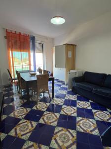 a living room with a table and a couch at Sant'Andrea in Capo dʼOrlando